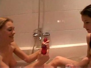 Lesbos play with a toy in a bath